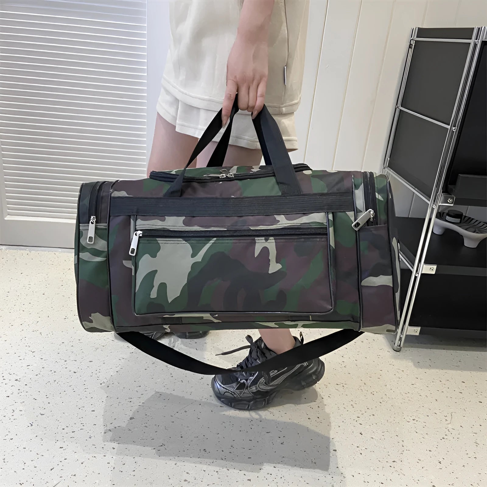 Camouflage coloured waterproof luggage bag with large capacity for travel.