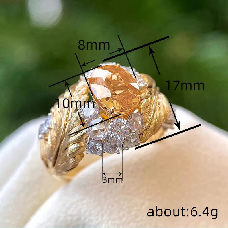 Embossed feather ring with geometric design and inlaid yellow zircon in gold colour