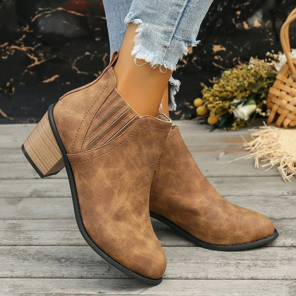 Black women's slip-on ankle boots with a pointed toe and thick square heel on a rubber sole.