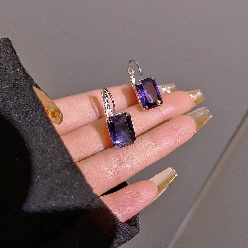 Women's square crystal copper earrings measuring 25mm by 10mm in purple, red and yellow colours