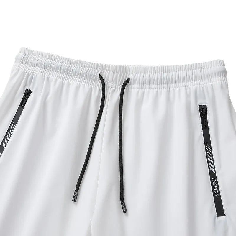 Men's black quick-dry loose-fit nylon sports shorts on a size chart background