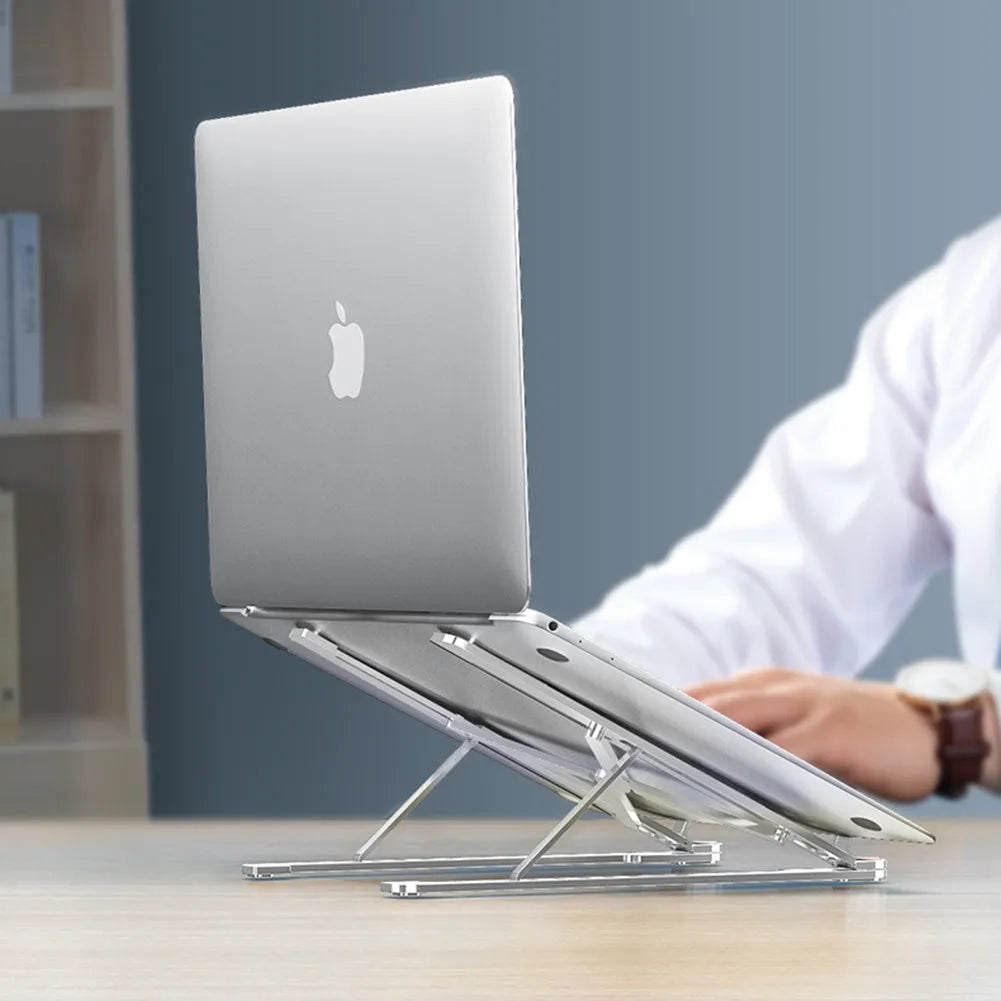 Silver aluminium folding laptop stand adjusted to medium height with a laptop in place.