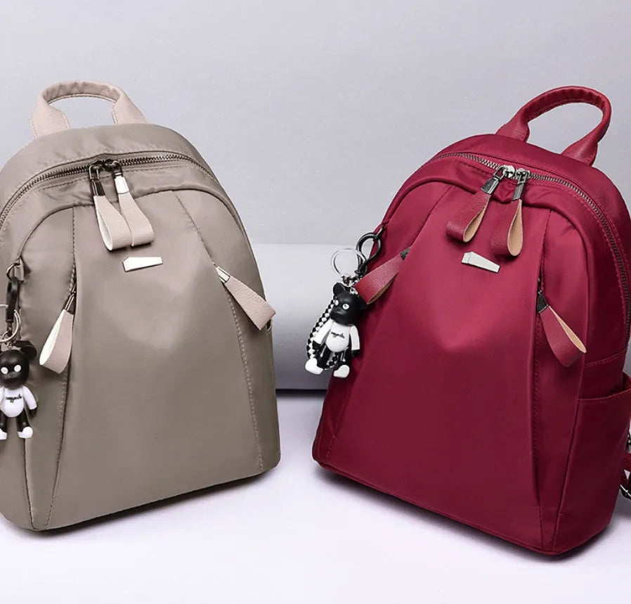 Medium square rucksack in wine red with front digging bag and dual straps.