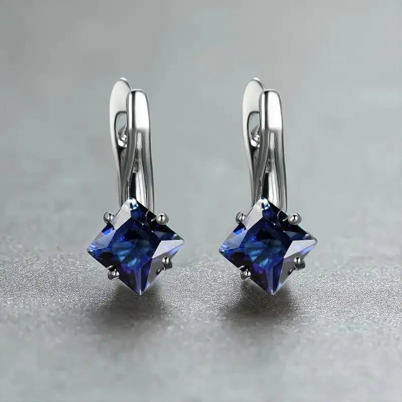 A pair of women's copper earrings with a diamond design and inlaid blue zircon stones.
