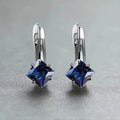 A pair of women's copper earrings with a diamond design and inlaid blue zircon stones.