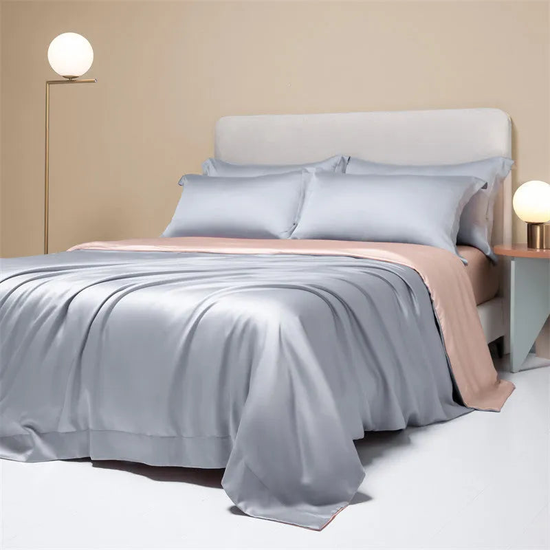 Luxury Lenzing Tencel bedding set in Aurora Blue on a bed, showing quilt cover, sheet, and two pillowcases.
