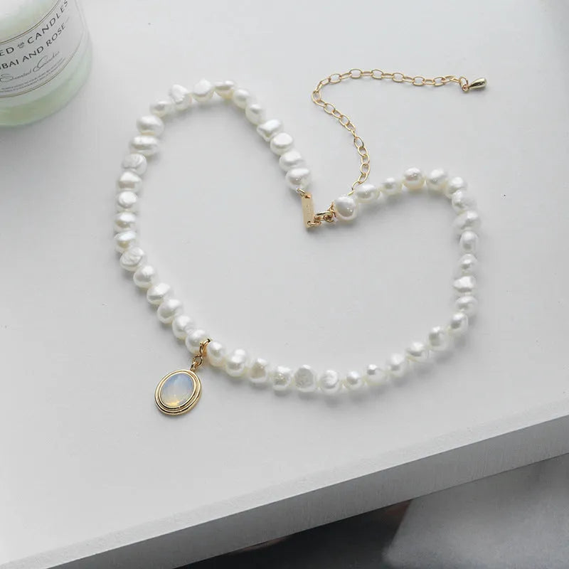 Sterling silver necklace with geometric pearl pendant showing adjustable length chain