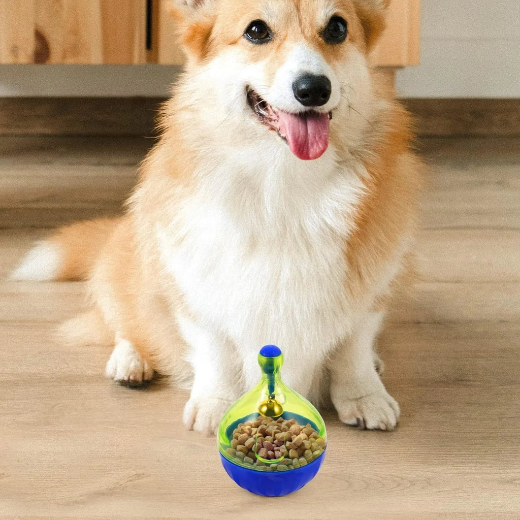 Blue and white tumbler-shaped pet treat dispenser toy on a wooden floor.
