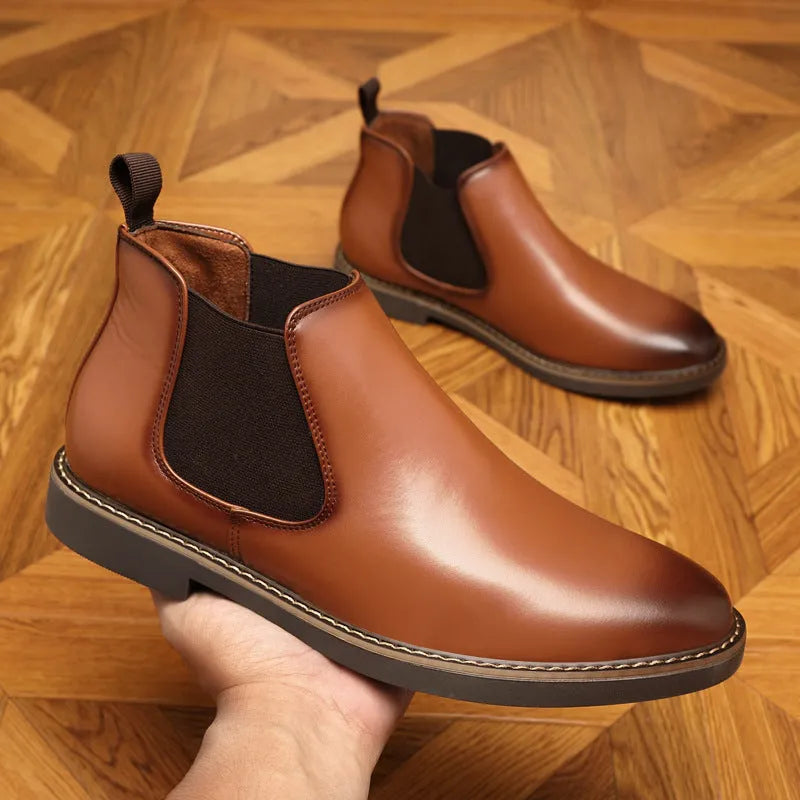 Black formal leather pointed-toe boots with a square heel and rubber sole on a white background.