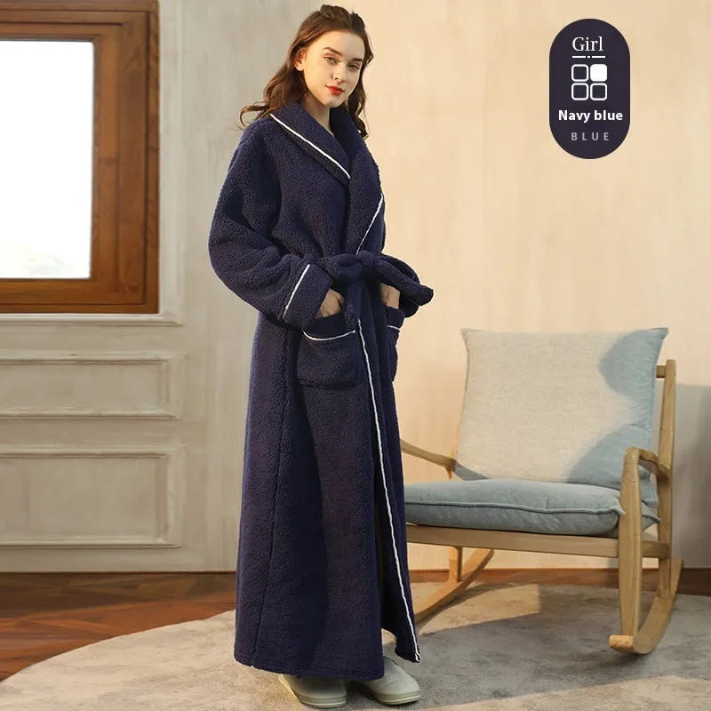 A man and woman wearing matching thick, navy blue flannel bathrobes in a European style cut.