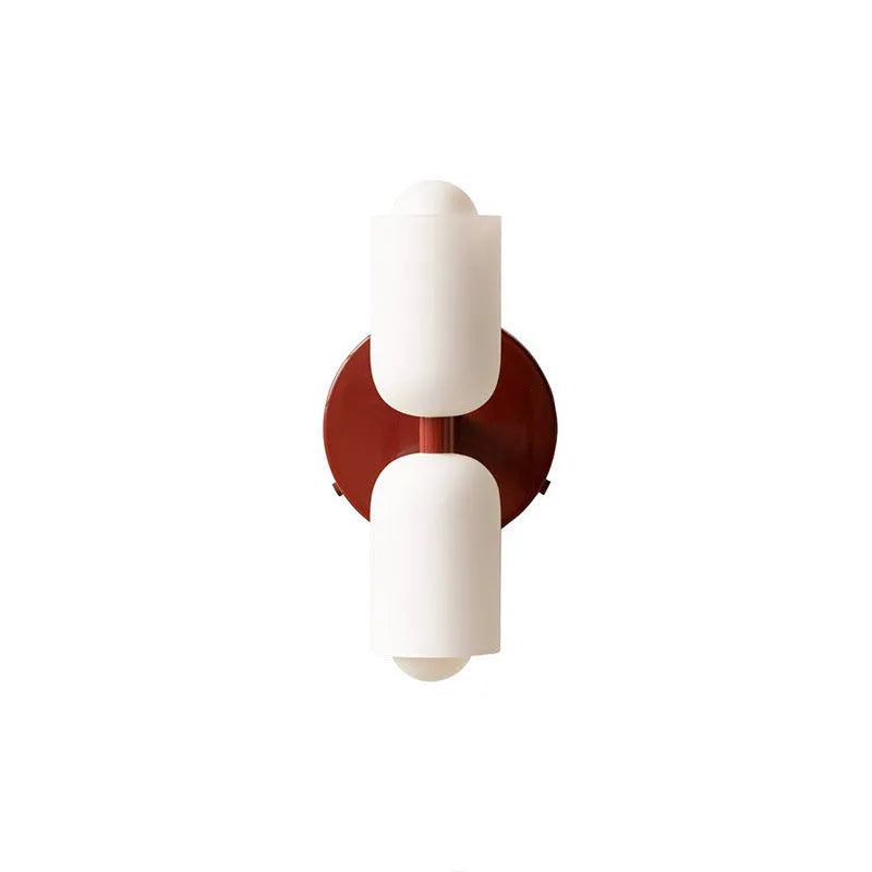 Cream base double head wall lamp with white glass shades against wall
