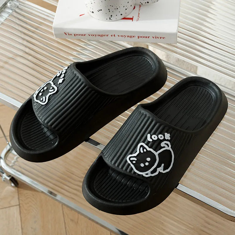 Women's pink EVA cat slippers with thick platform sole on a wooden floor.