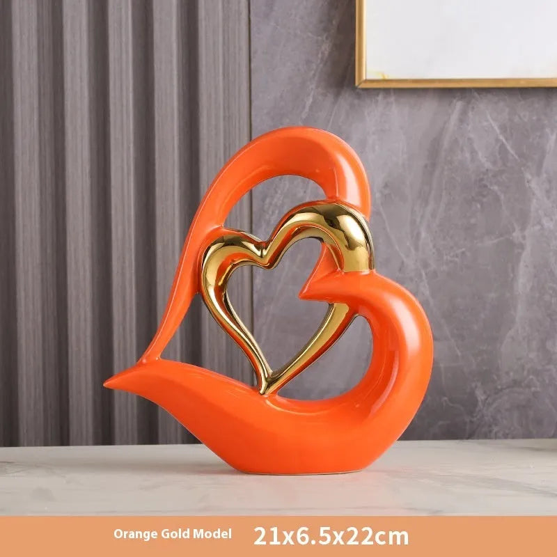 Modern geometric heart ornament in metallic finish displayed on shelf
