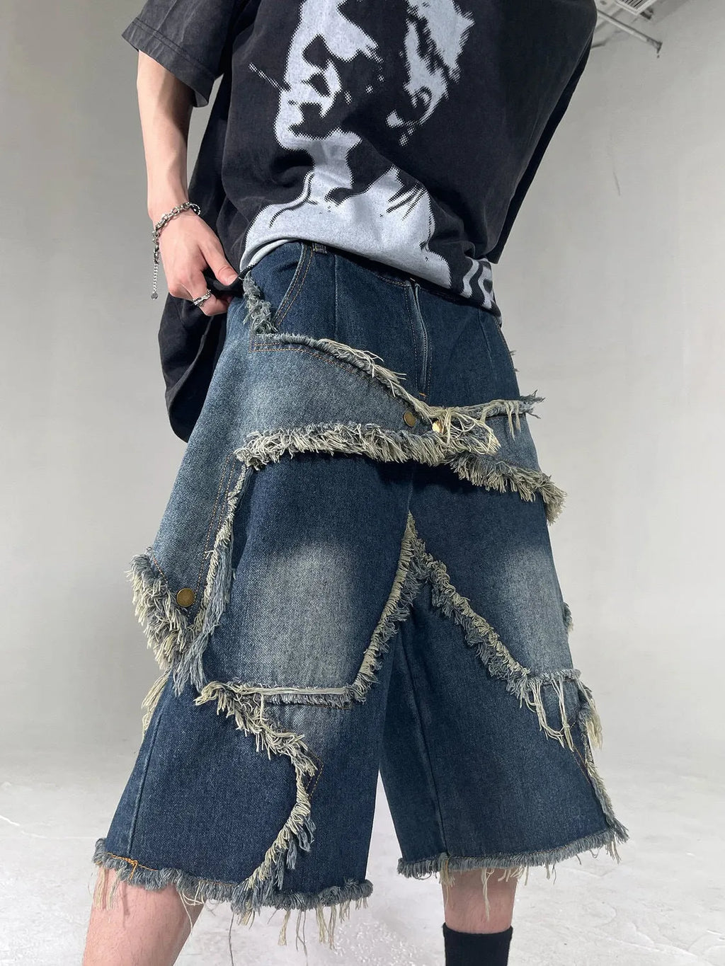 Blue denim shorts with frayed five-pointed star design and loose fit for summer casual wear