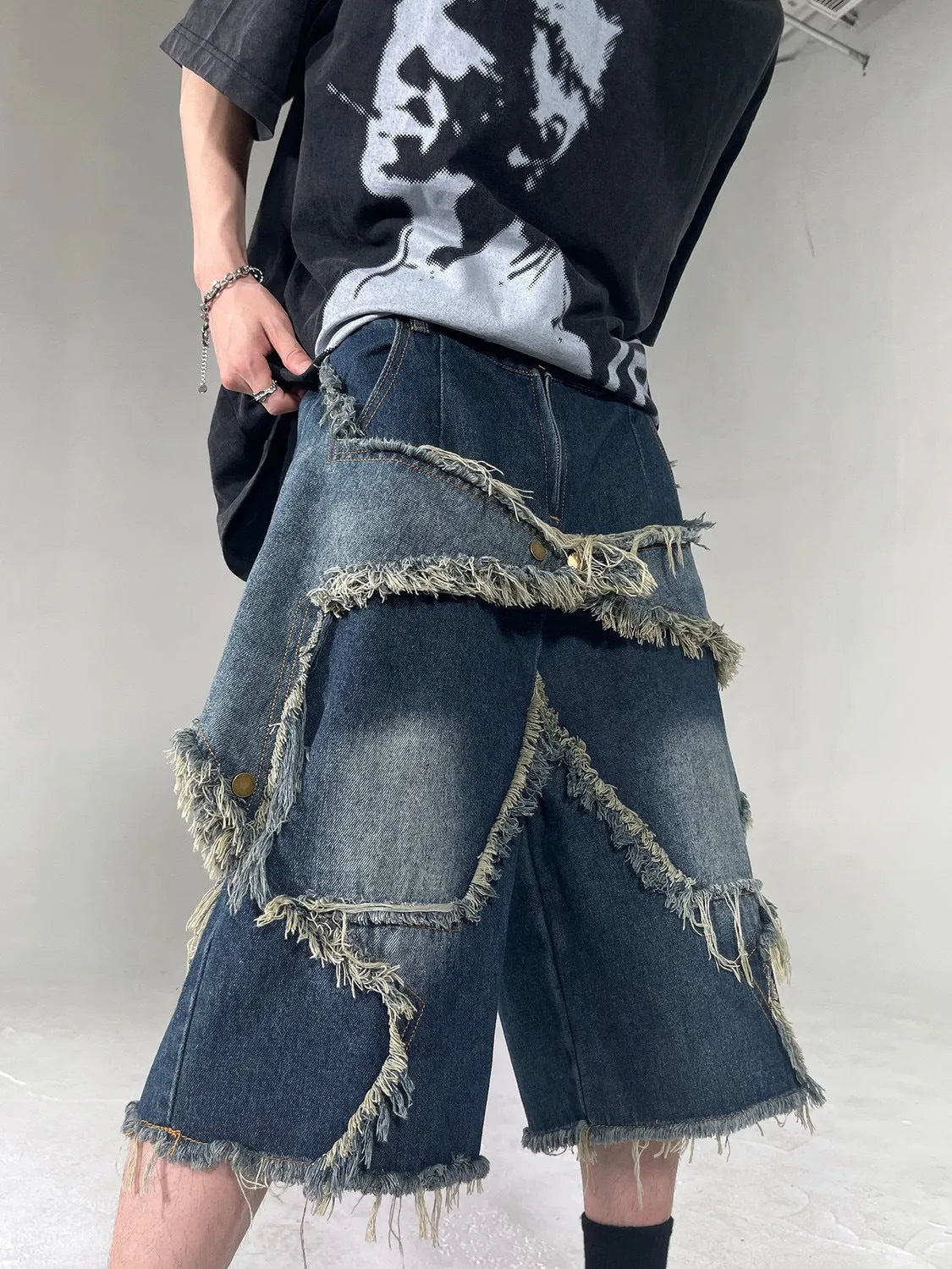 Blue denim shorts with frayed five-pointed star design and loose fit for summer casual wear