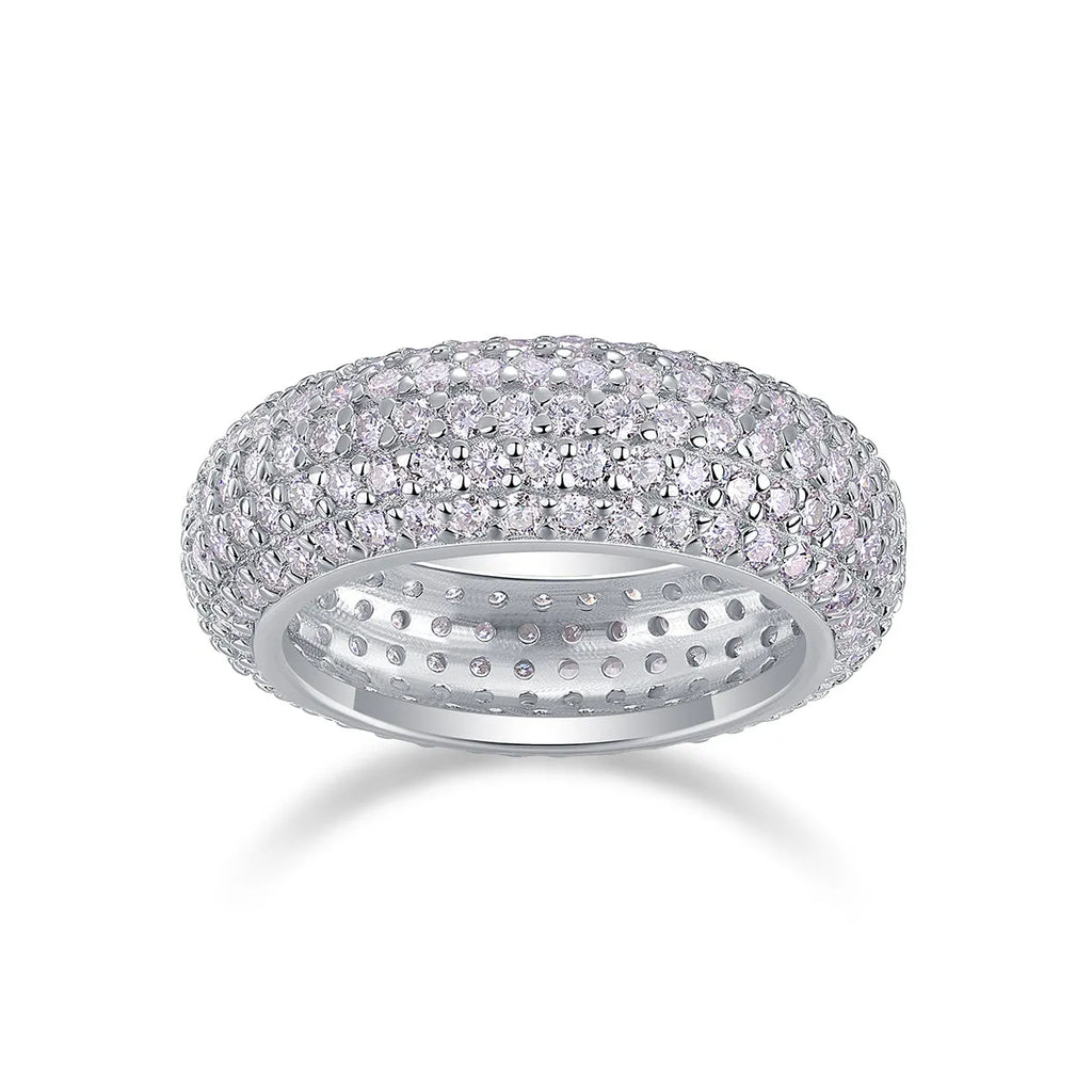 Moissanite wedding ring with S925 silver platinum plated band on flat surface showing stone and certificate