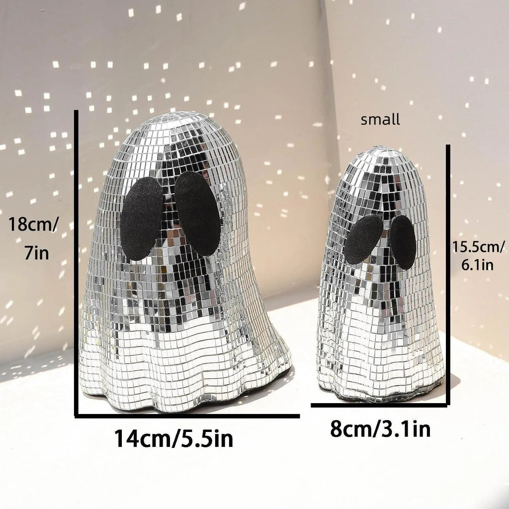 Silver glass Halloween ghost decoration with mosaic mirror patch design on a desktop.