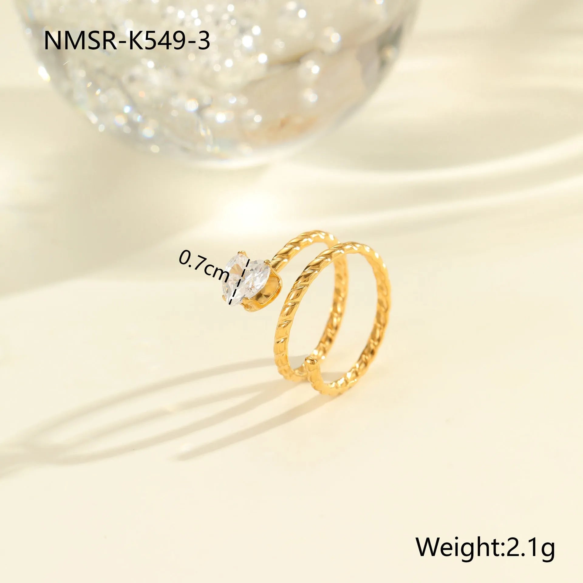 Gold electroplated adjustable ring with geometric zircon design on a stainless steel band.
