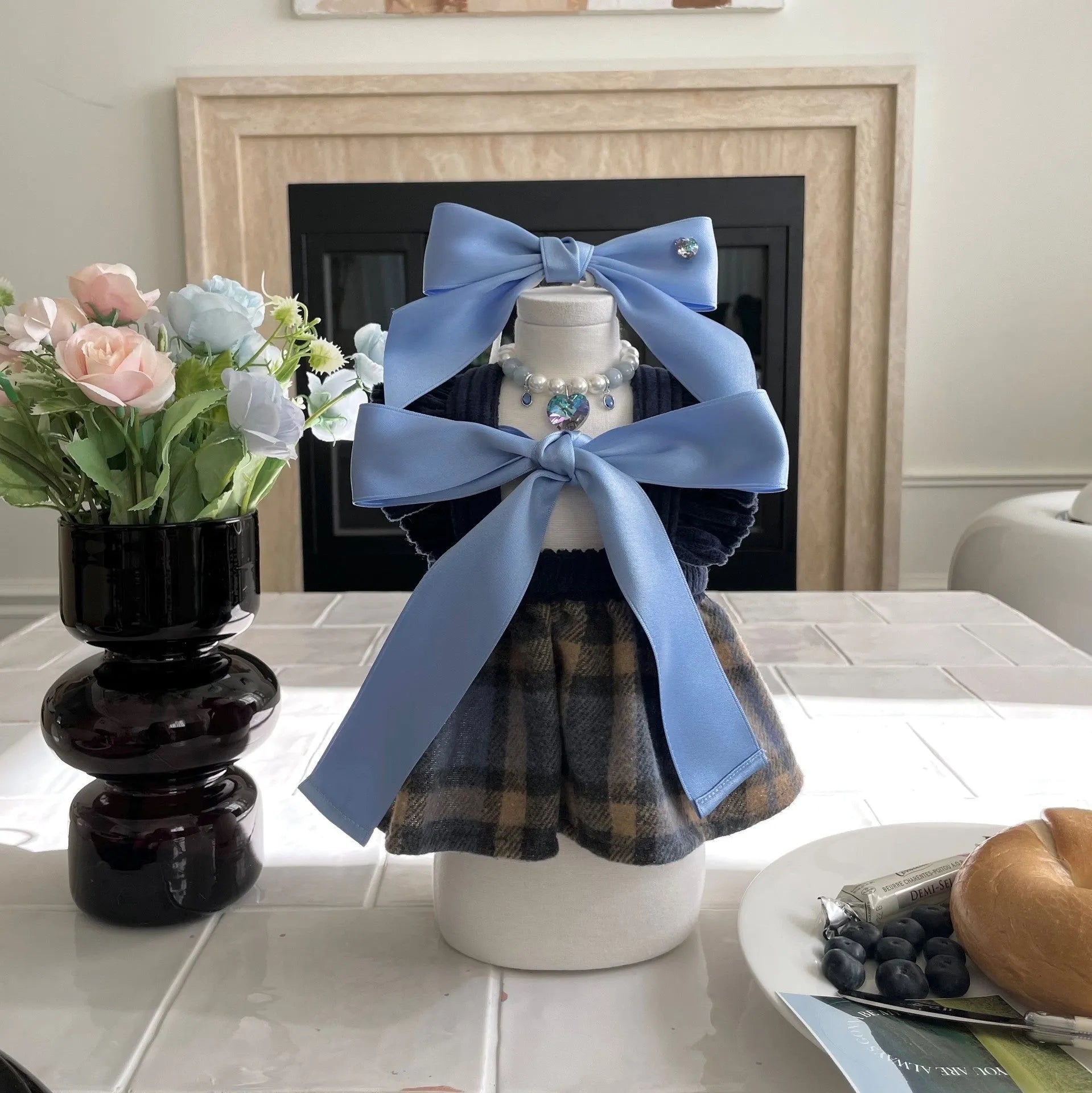 Blue princess bow dog hair band with adjustable tension on a small dog