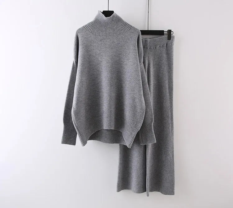 Women's milky white acrylic two-piece set with long sleeve top and wide-leg trousers on a hanger.