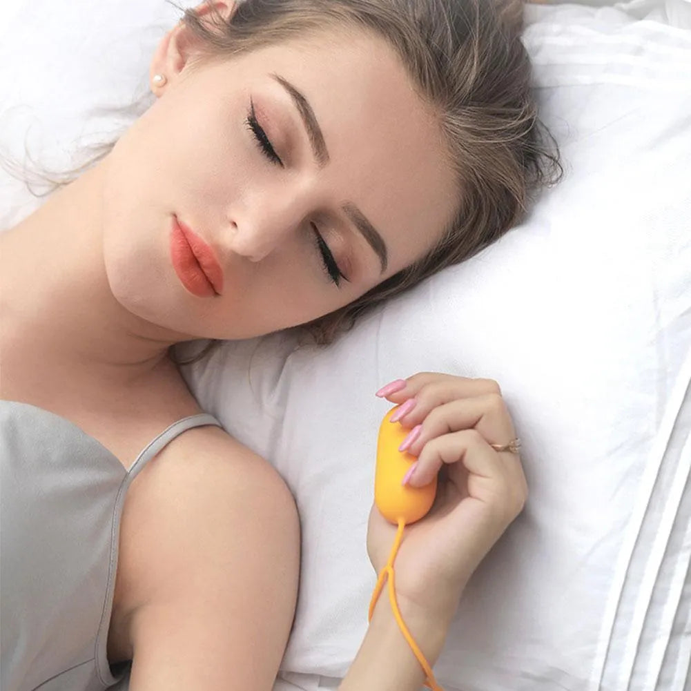 Handheld micro-current sleep aid device in grey, green, or orange colours with USB charging cable
