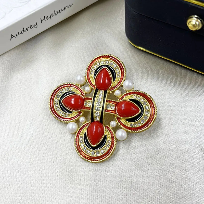 Close-up of a vintage medieval baroque cross brooch in zinc alloy with crystal accents, showing intricate detail.