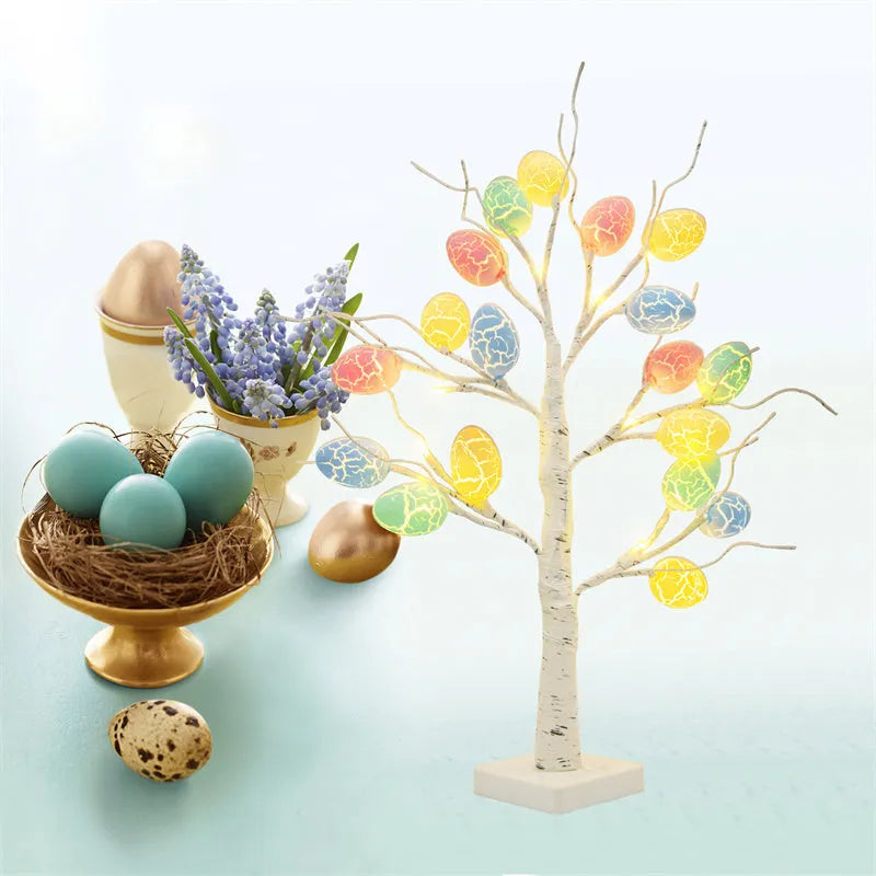 White plastic birch tree Easter decoration with warm white LED lights and hanging coloured eggs on adjustable branches.