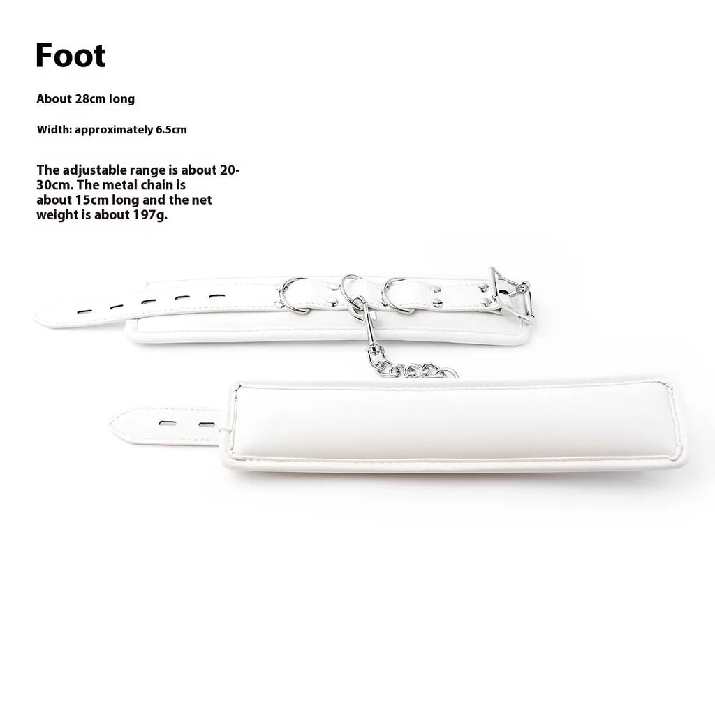 White PU sponge bondage set showing handcuffs, foot cuffs, and a neck cuff arranged together.