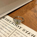 Creative butterfly design women's ring in copper with oil drip finish, showing an open loop style.