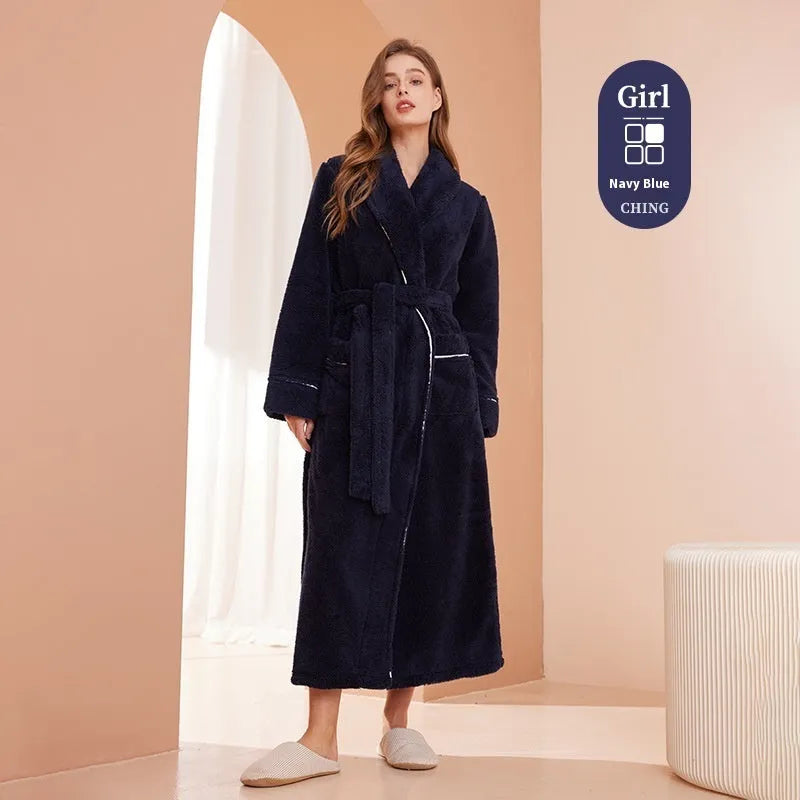 A man and woman wearing matching thick, navy blue flannel bathrobes in a European style cut.