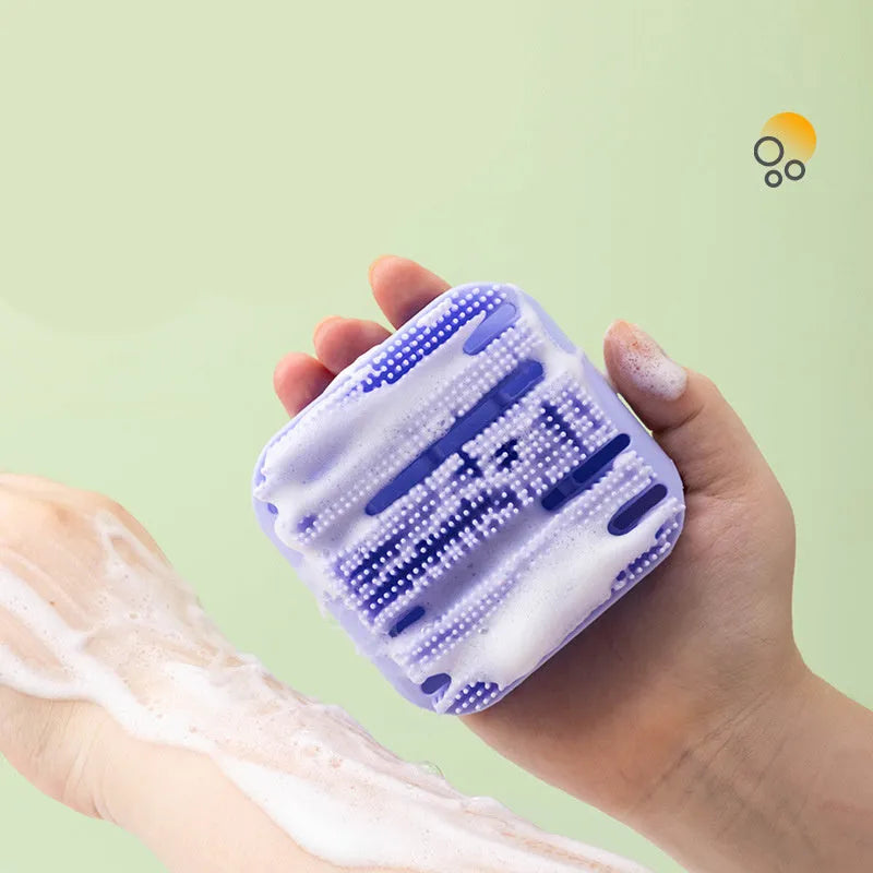 Blue silicone scalp massager brush with hand-strap handle for washing and massaging hair.
