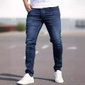 Dark blue men's slim-fit cotton jeans with a skinny leg opening on a plain background.