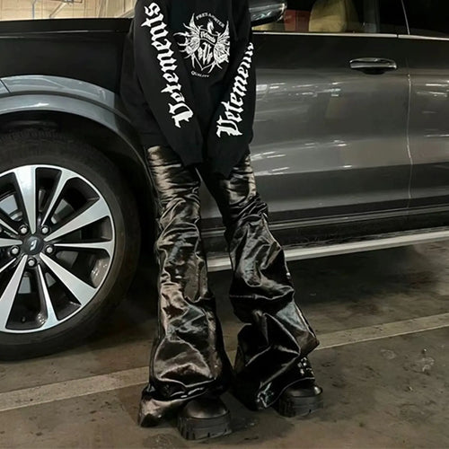 Black women's skinny jeans with a shiny patent leather coating on the denim fabric, shown in a straight-leg cut.