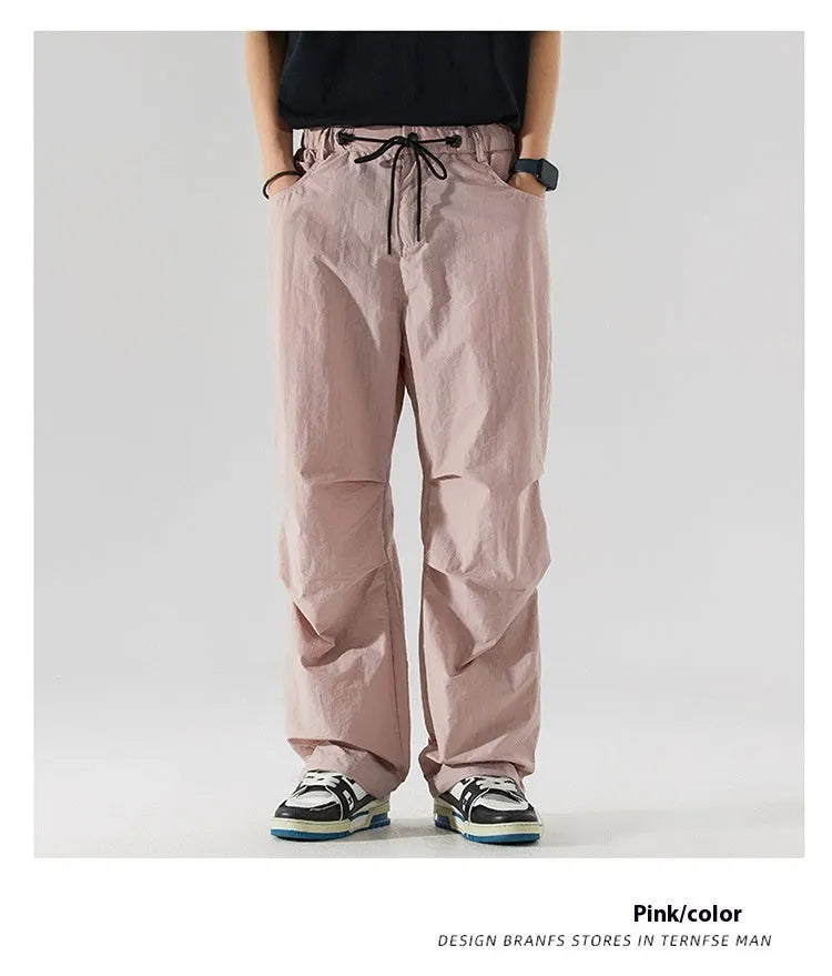 Men's loose straight-leg casual trousers in thin ice silk nylon fabric, shown in apricot colour.