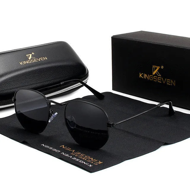 Classic round retro sunglasses for men in gun grey finish with UV400 lenses on a wooden table.
