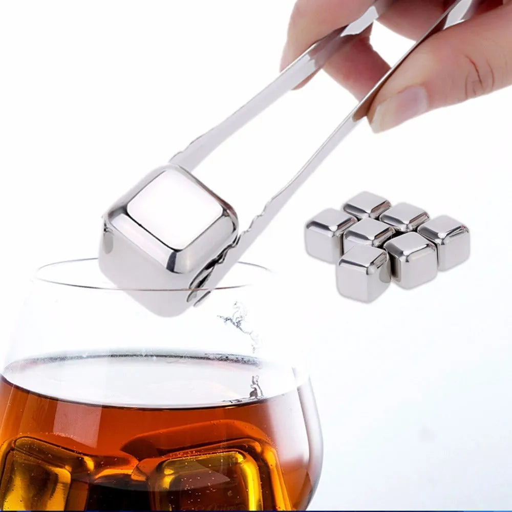 Set of eight stainless steel whiskey chilling stones and metal clip in storage box.