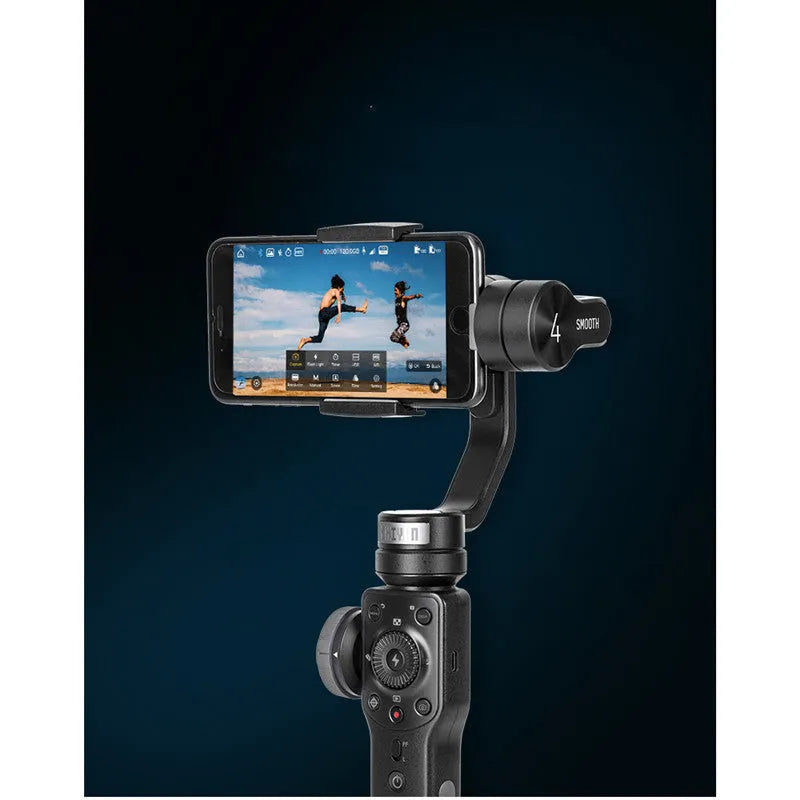 Black handheld smartphone gimbal stabilizer on a table