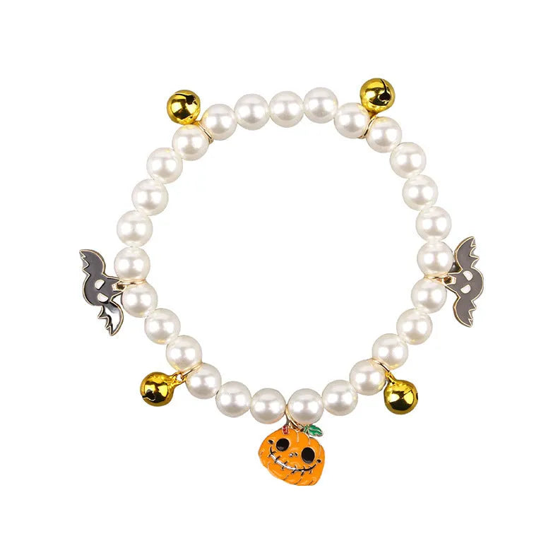 Halloween pet collar with simulated pearls and a purple ghost pumpkin charm around a cat's neck.