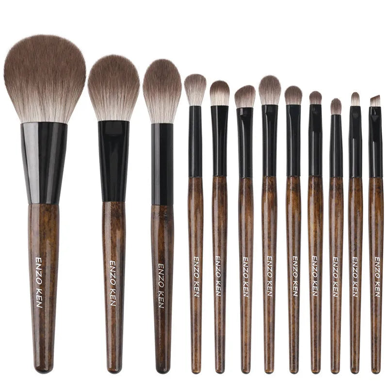 12-piece makeup brush set with wooden handles in a grey PU zip case