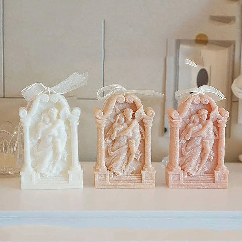 Flexible food-grade silicone mold for making hug angel couple figurines from wax, chocolate, or plaster.
