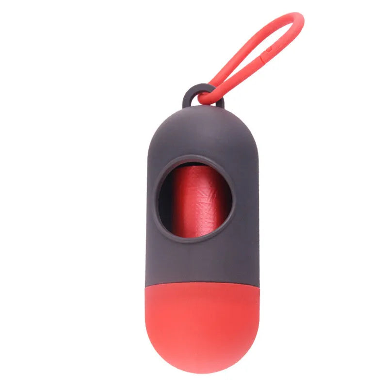 Black plastic dog poop bag dispenser with Velcro strap and a side metal hook.