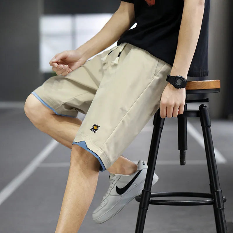 Korean style straight leg loose beach shorts in polyester, shown in green on a mannequin.