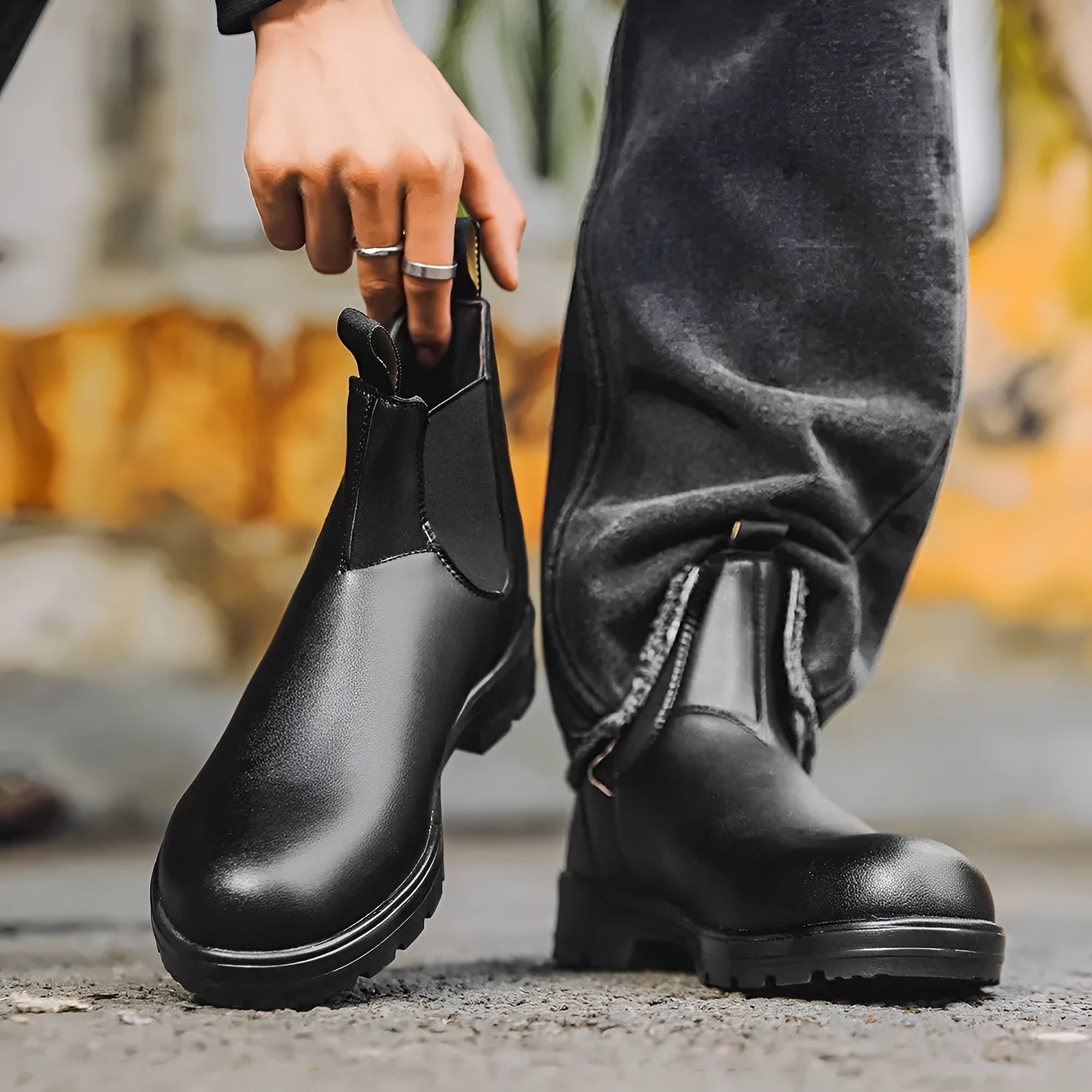 Vintage brown unisex Chelsea boot with frosted PU upper and car suture detailing on a wooden floor.
