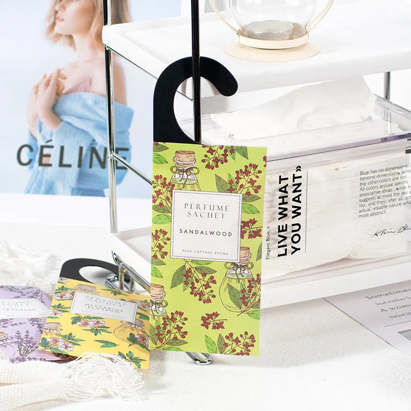 Pack of five household wardrobe sachets with lavender, rose, jasmine, sandalwood, vanilla, apricot blossom aromas on a shelf