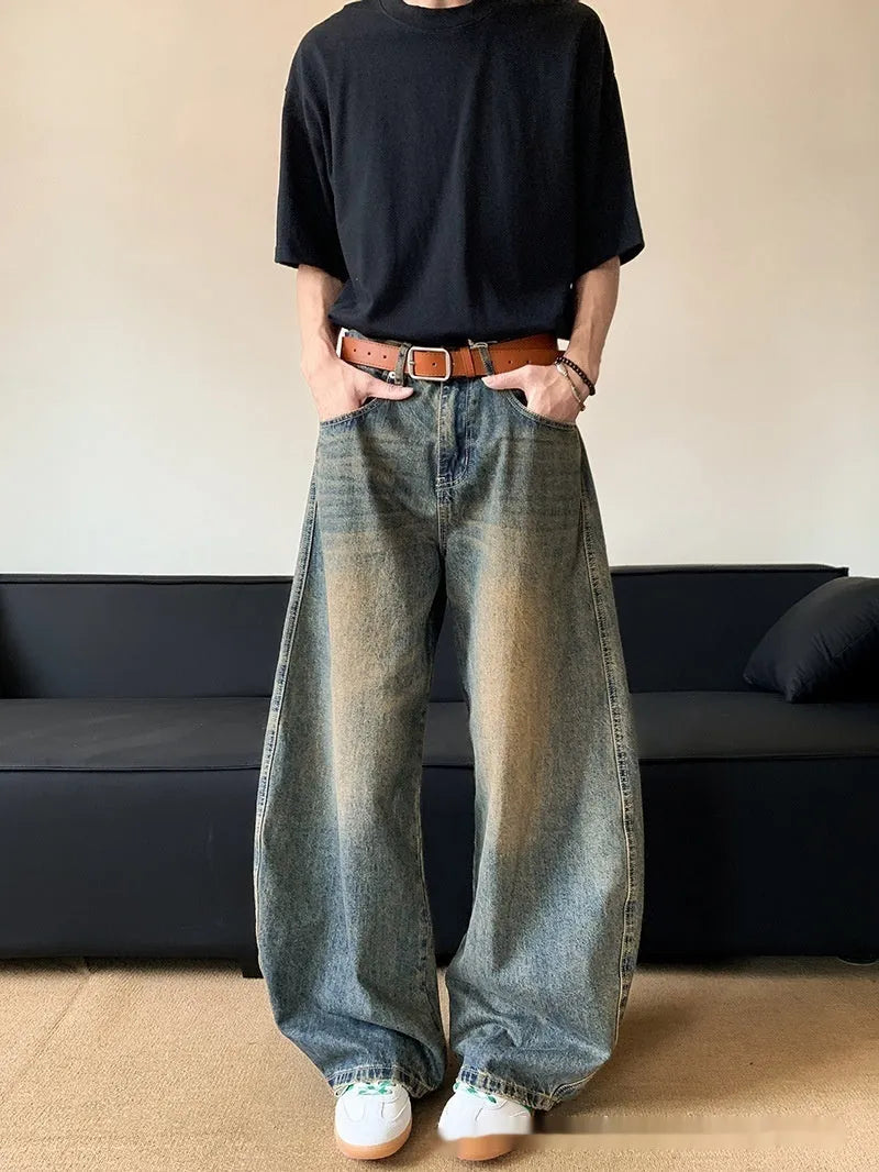 Man wearing Retro Blue distressed wide-leg denim jeans with a slimming silhouette and mid-waist fit.