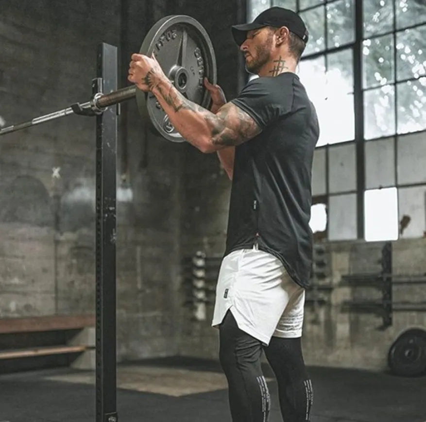 Plain men's fitness shirt in army green, made from cotton and spandex blend, shown on a hanger.