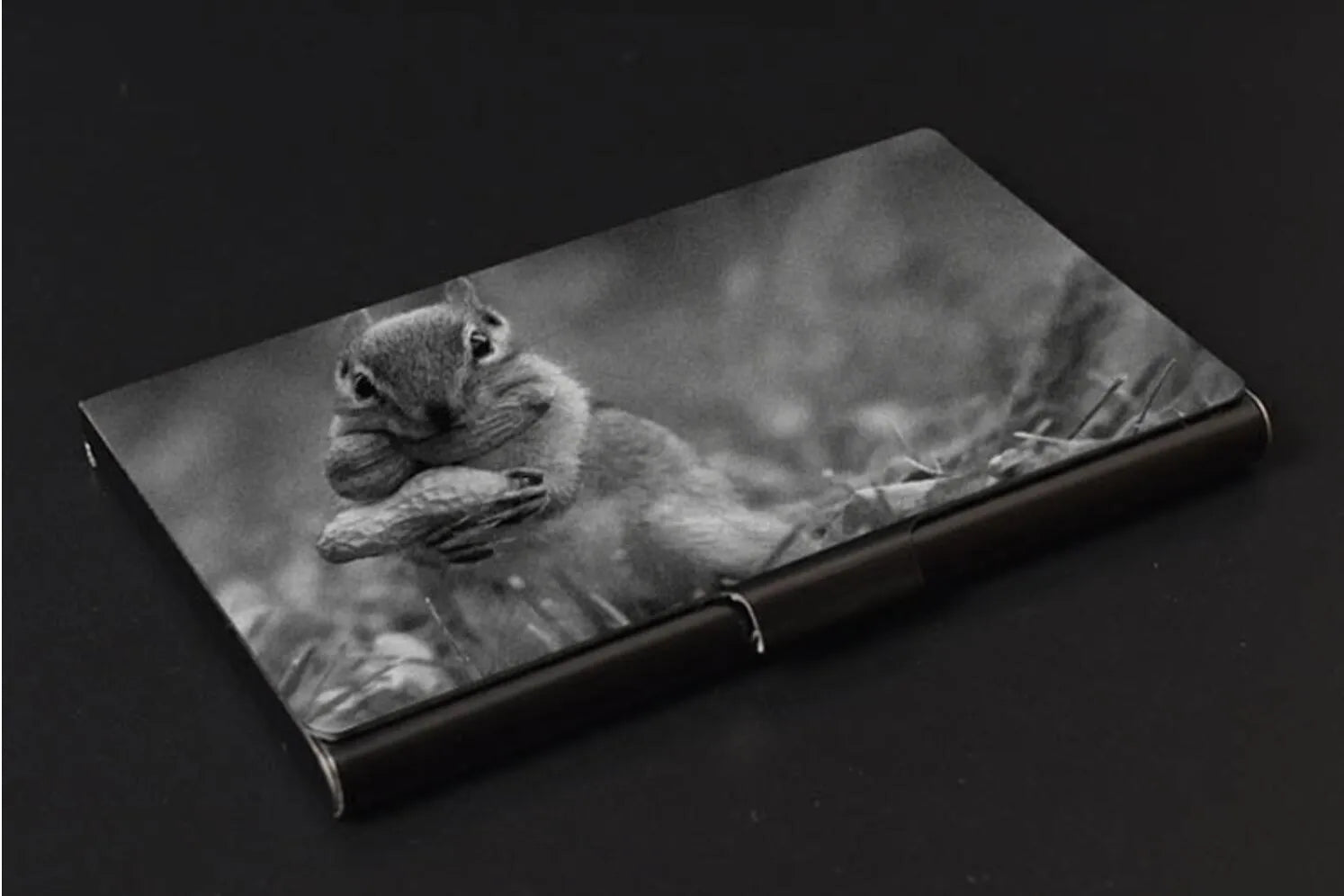 Metal titanium business card holder in black finish holding business cards