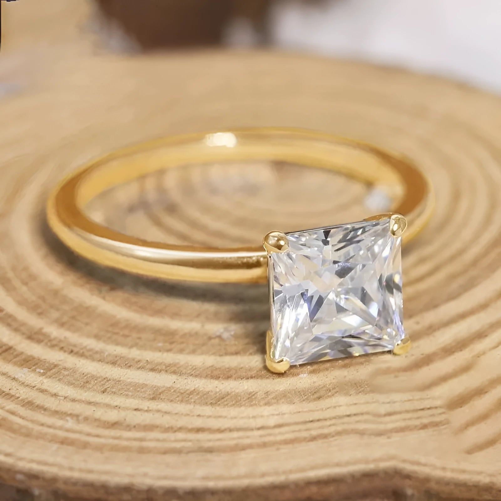 A simple geometric women's ring made of 925 silver with a round zirconium stone, shown in silver, gold, and rose gold colour options.