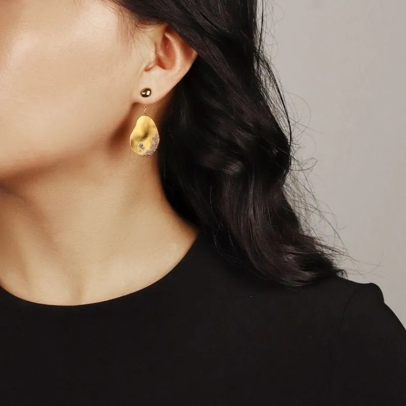Asymmetric Chinese style earrings with gold-plated finish and zircon flower design in silver tone