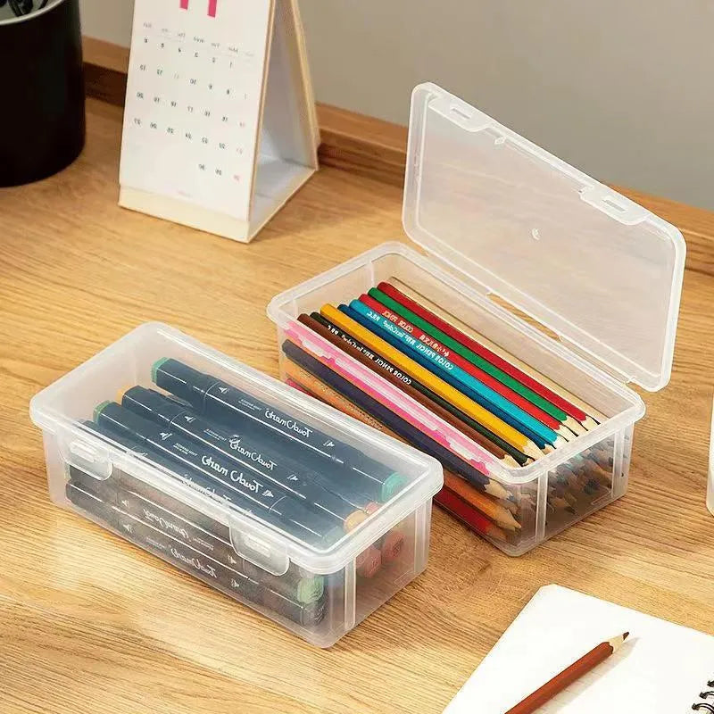 Large transparent plastic storage box full of coloured pencils and crayons